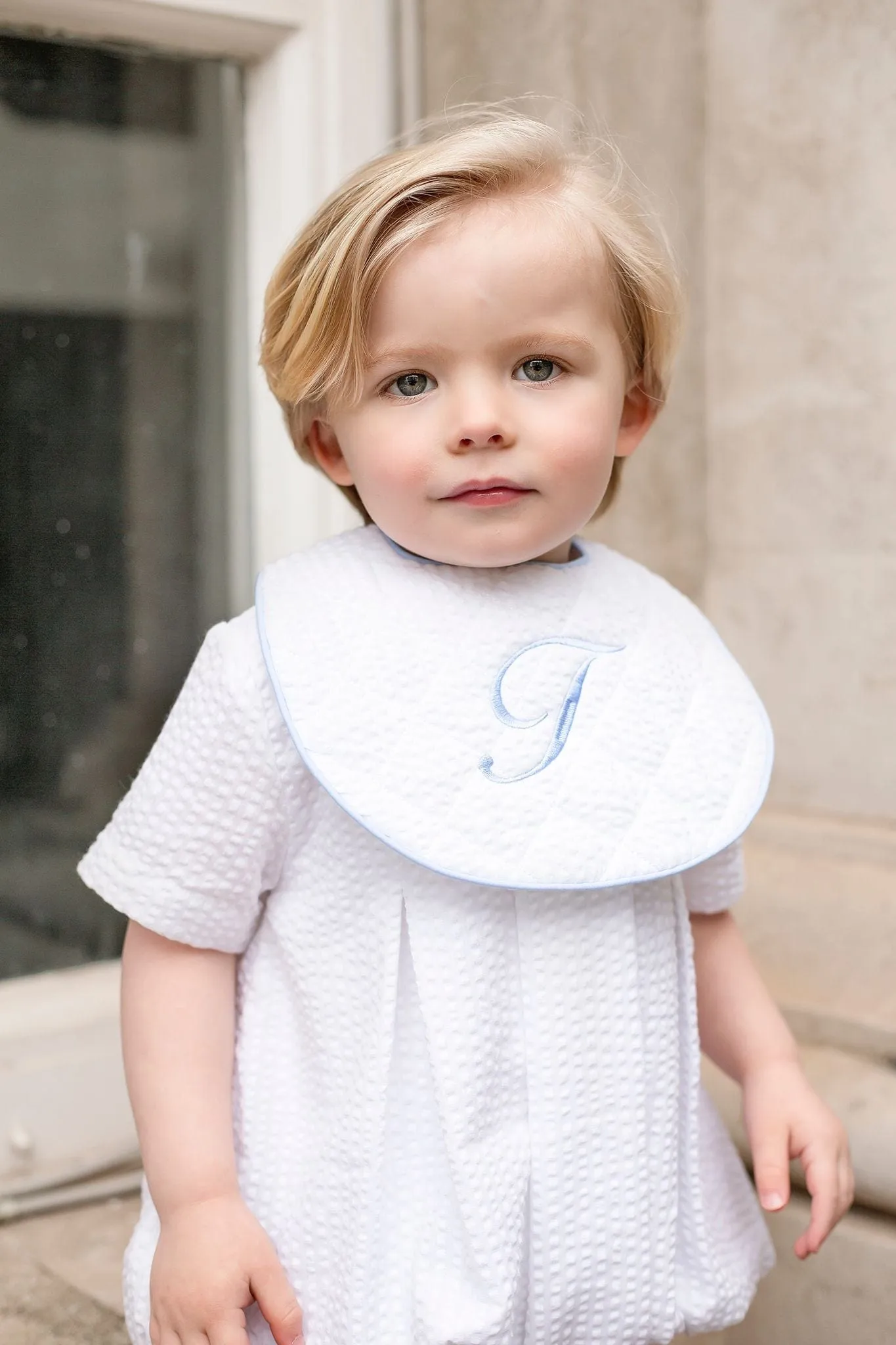 Boys White Seersucker Quilted Bib Trimmed With Blue