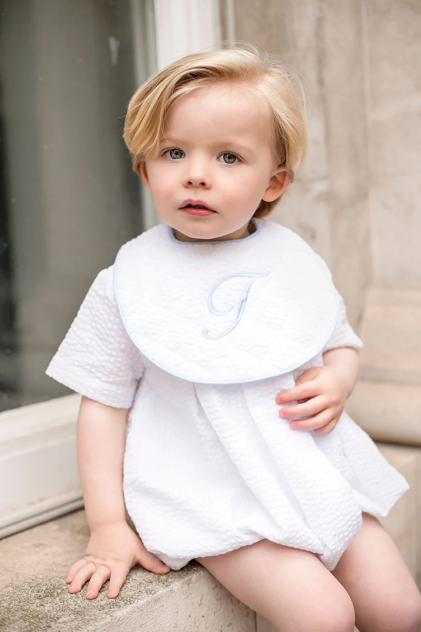 Boys White Seersucker Quilted Bib Trimmed With Blue